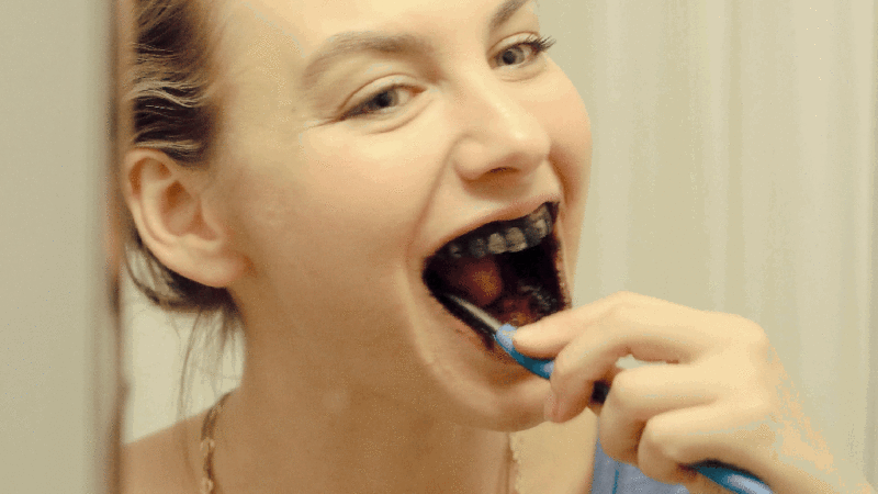 brushing teeth with activated charcoal