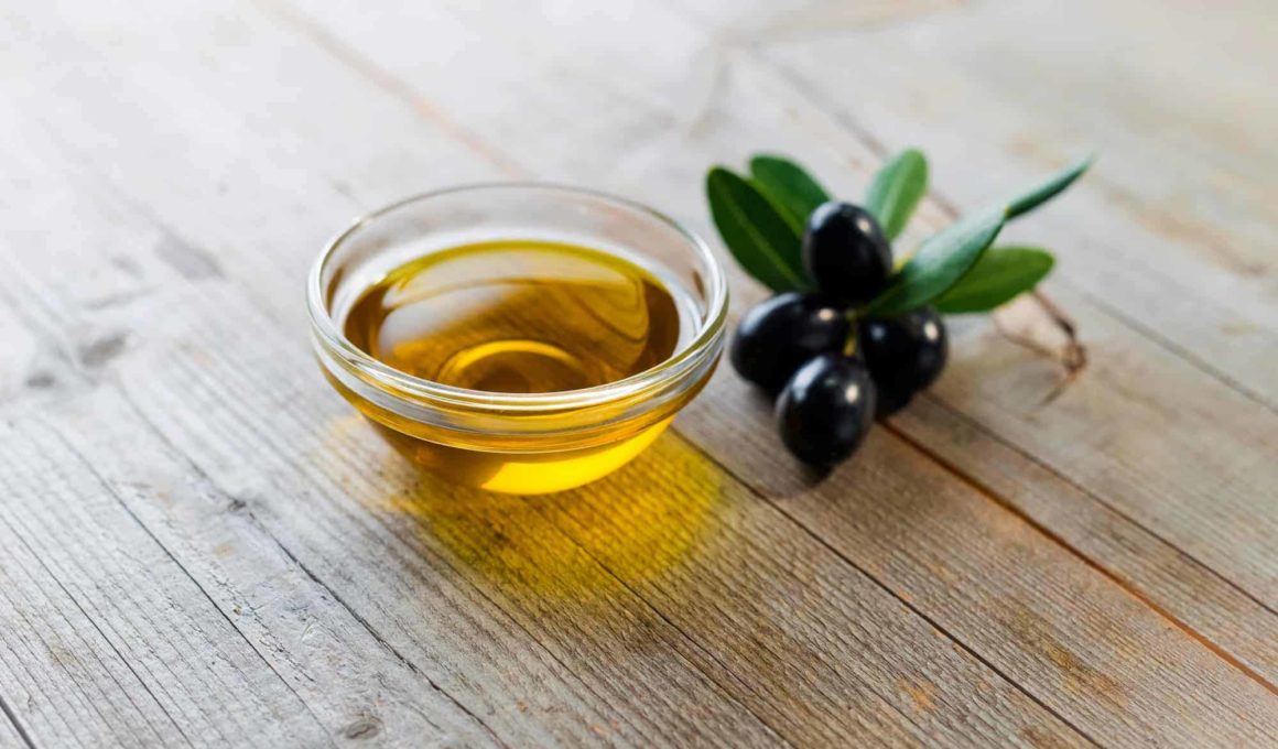 Olive oil with leaves and olives