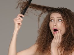 Hair loss woman brushing curly hairstyle