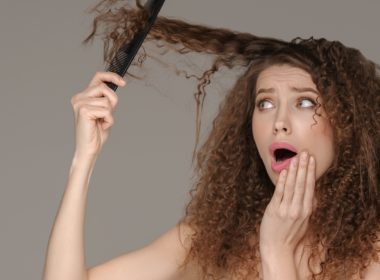 Hair loss woman brushing curly hairstyle