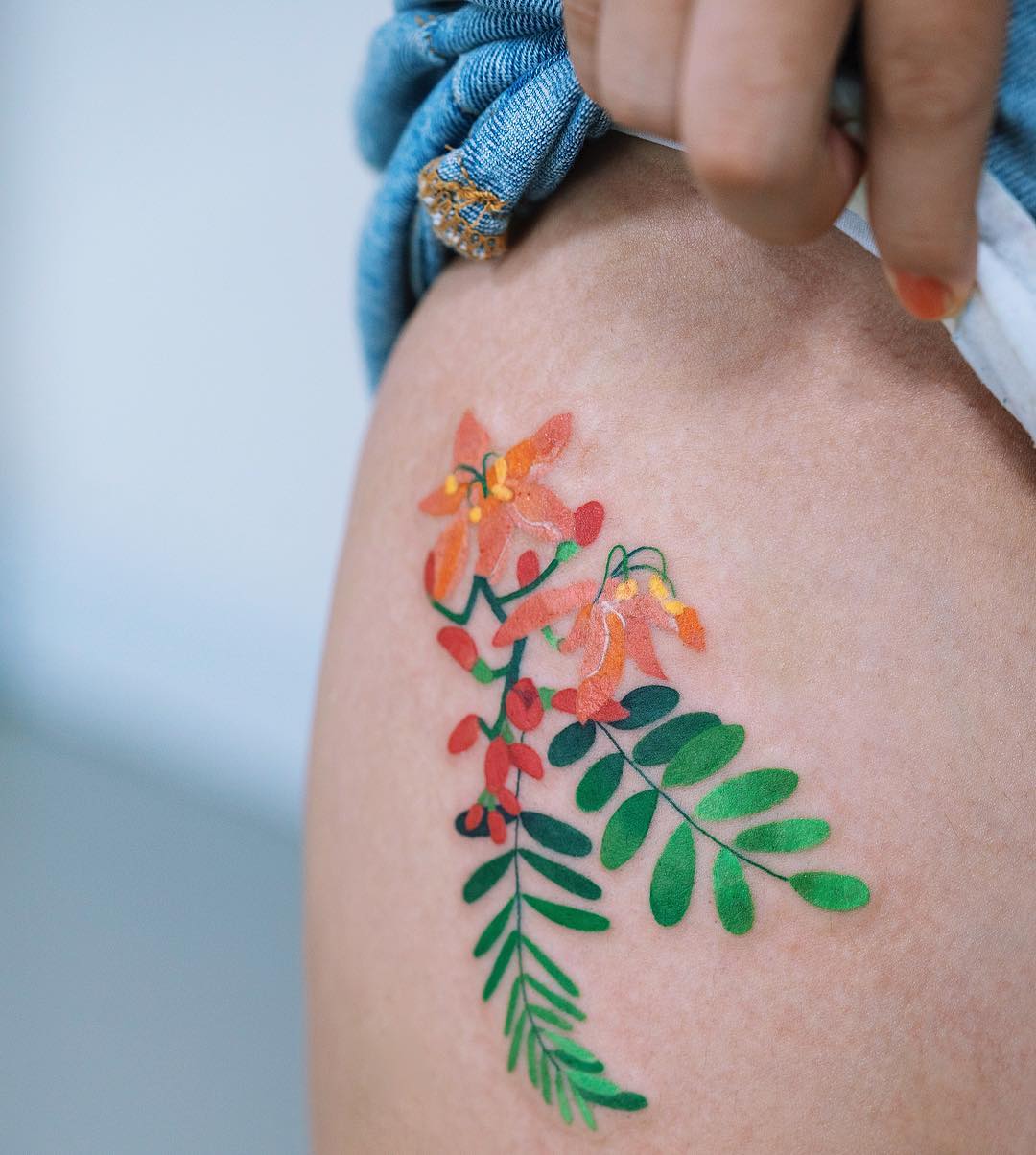 Brightly Colored Flower Hip Tattoo