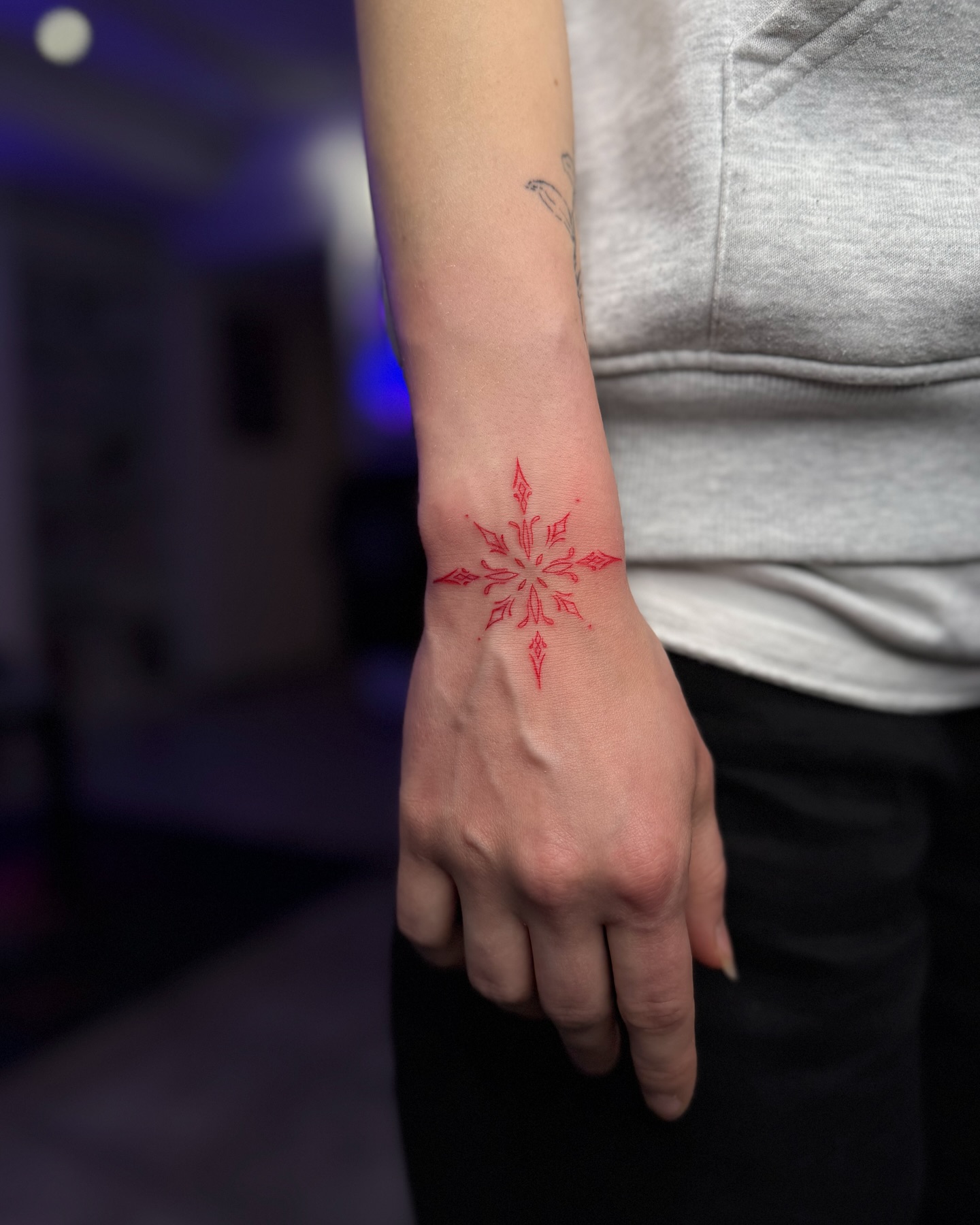 Red Ink Wrist Tattoo