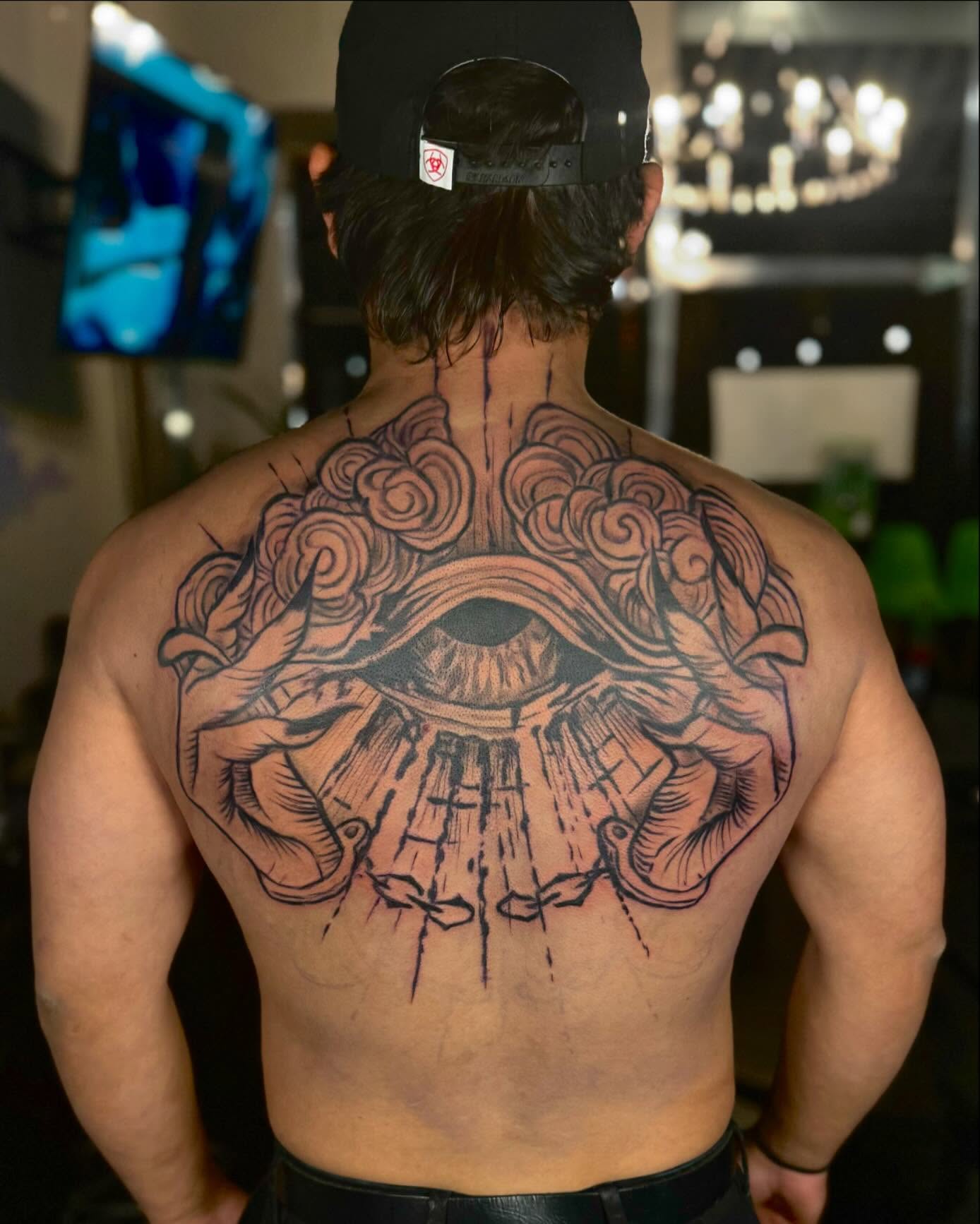 https://smashingoutfits.com/wp-content/uploads/2024/12/All-Seeing-Eye-Upper-Back-Tattoo.jpeg