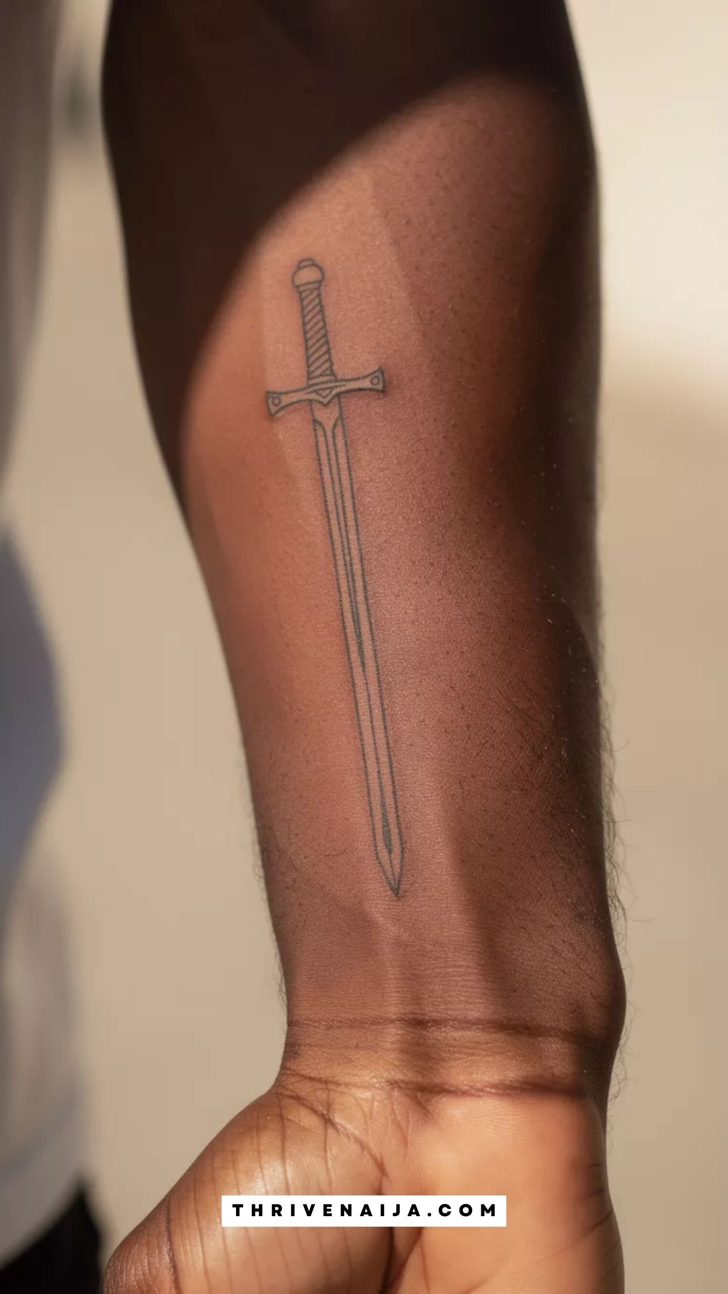 Tiny Sword Forearm Tattoo