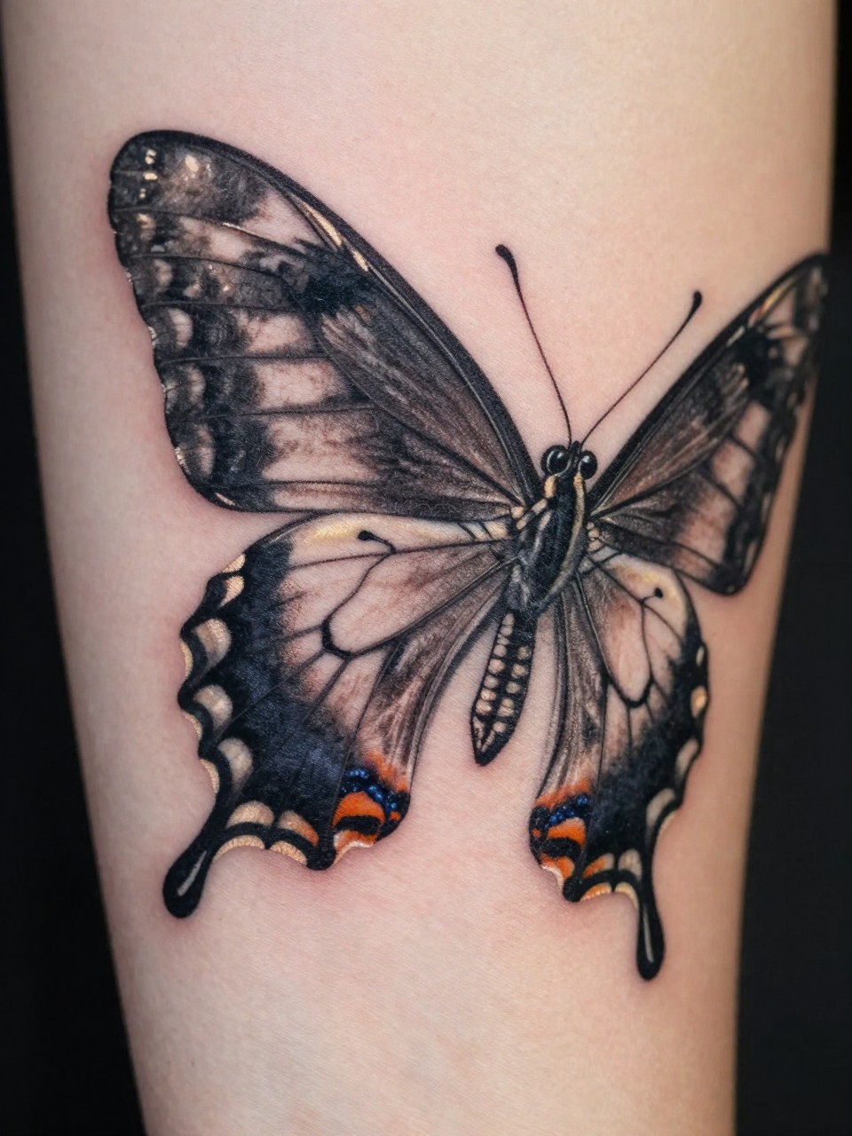 Macro photograph of a sleeve section tattoo: a hyper-realistic Pipevine Swallowtail with incredible wing texture and shading, appearing to cast a shadow on the skin below it."