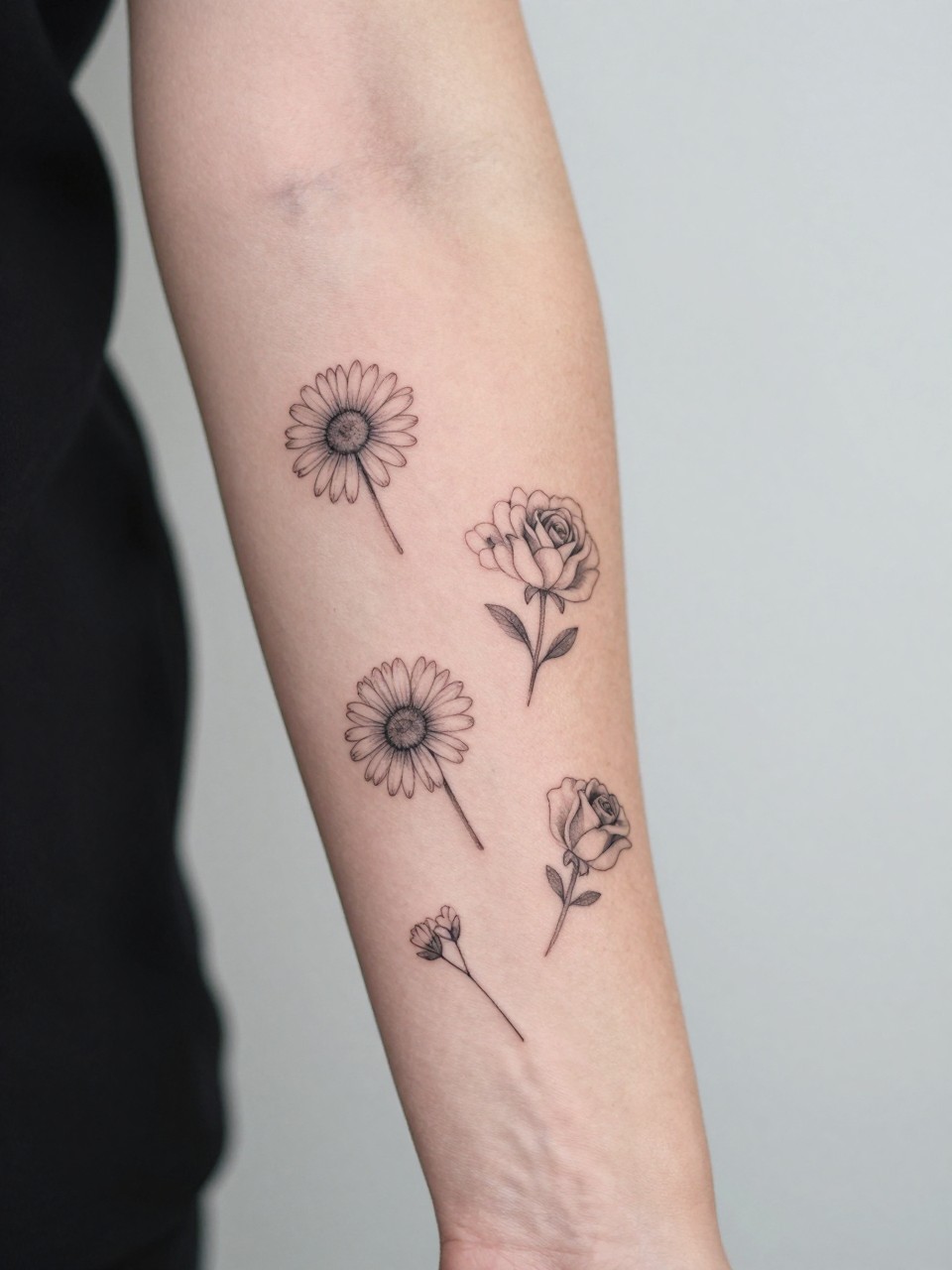 Image Prompt: "Close-up of a minimal floral patchwork sleeve tattoo on the arm, separate fine line flower tattoos including daisies, roses, and tiny buds placed across the arm, soft shading, realistic skin texture, delicate rings visible, modern feminine tattoo inspiration photo, clean minimal background, tattoo collection is the main focus (no watermarks on images)"