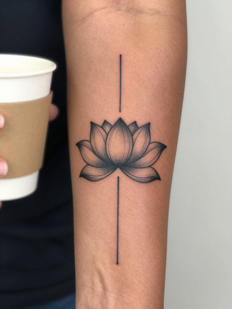 Image Prompt: "Design-focused close-up of a lotus flower tattoo connected to an unalome line on the forearm of black feminine woman, black ink fine line design, clean spiritual style, soft dotwork accents, subtle shading in petals, realistic skin texture, coffee cup softly blurred nearby, modern feminine tattoo inspiration image, minimal background, tattoo is the main subject (no watermarks on images)"