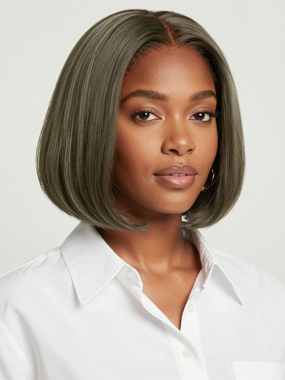 Image Prompt: A pretty black woman with a chin-length ash matcha chocolate bob, smooth rounded bob shape with a soft bend at the ends, muted ash brown hair color with soft matcha green undertones, medium skin tone, fresh natural makeup, glossy nude lips, small gold earrings, white button-up shirt, bright clean studio background, soft flattering lighting, realistic beauty editorial photography, detailed bob shape and cool earthy shine, no text, (no watermarks on images)