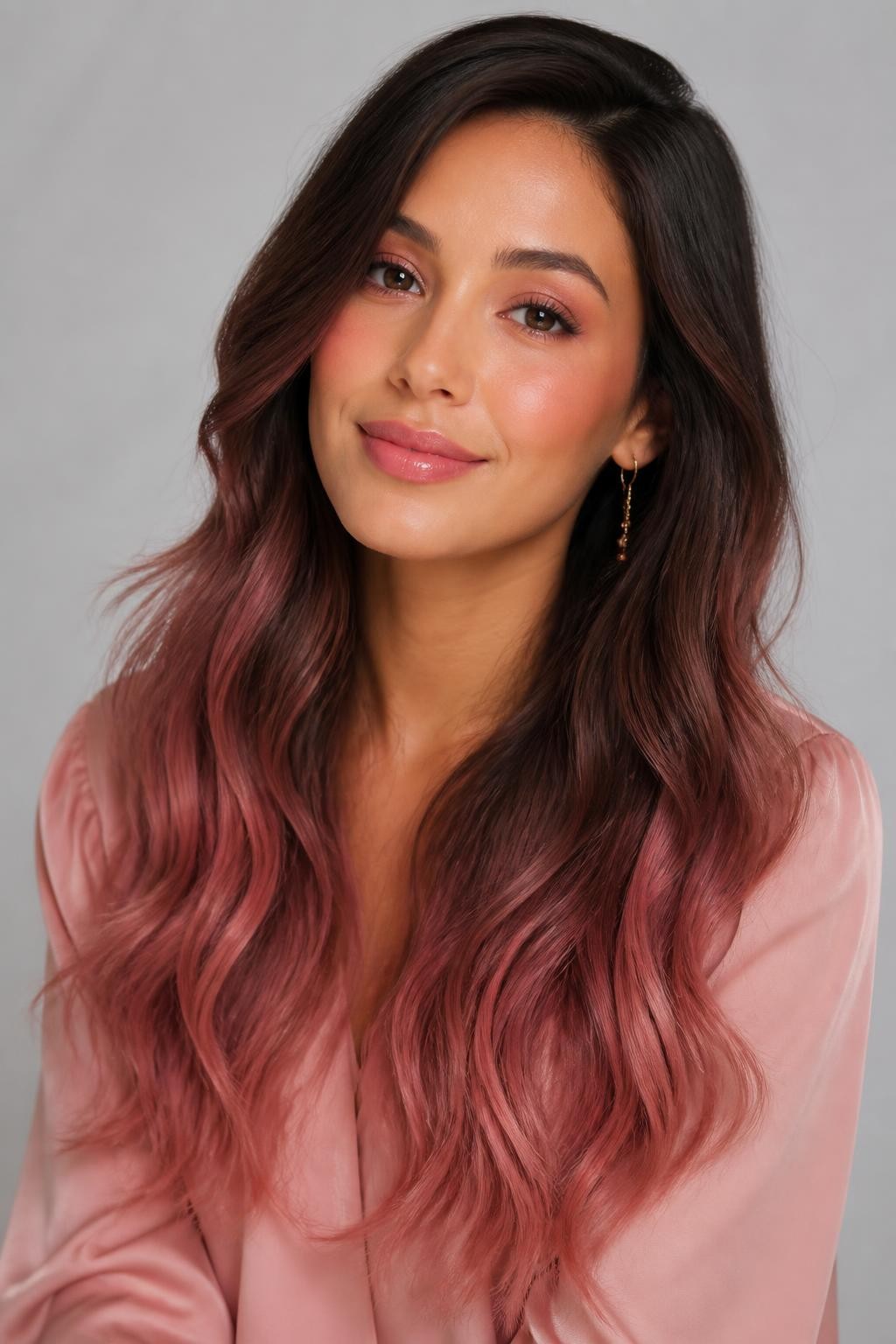 Image Prompt: A pretty brunette woman with long rose brown ombre hair, dark brown roots fading into muted rosy-brown mid-lengths and soft rose-tinted ends, loose waves, warm medium skin tone, soft pink makeup, glossy lips, delicate gold earrings, blush pink blouse, clean studio background, soft diffused lighting, realistic DSLR beauty portrait, detailed rosy brunette color blend, no text, (no watermarks on images)