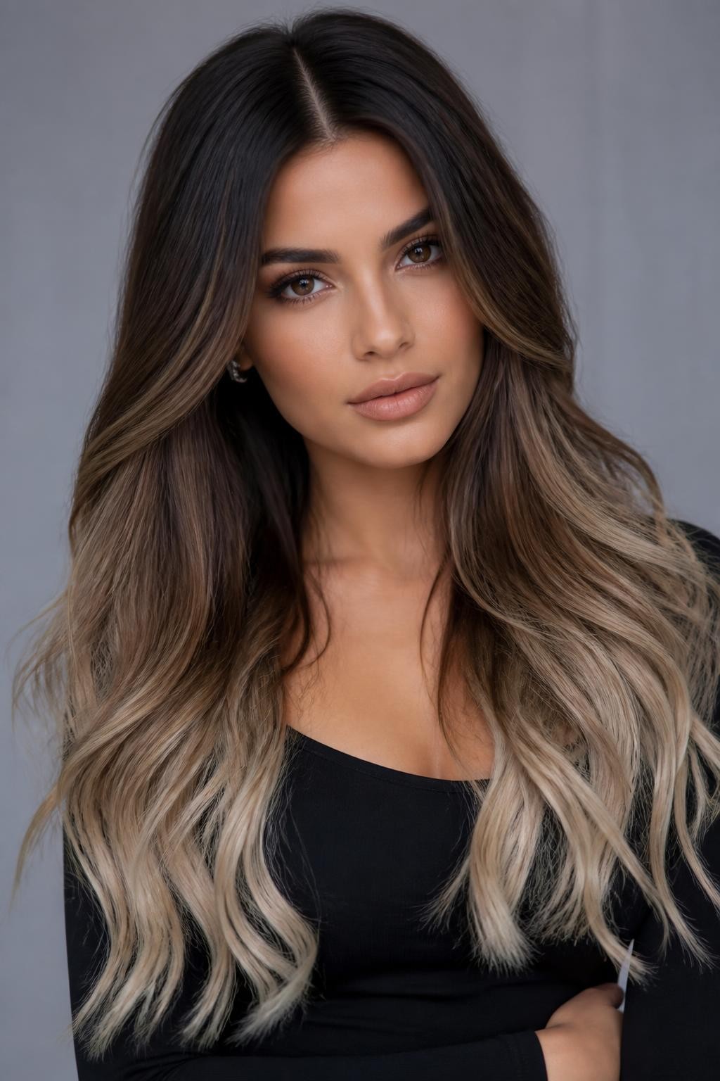 Image Prompt: A stylish brunette woman with long chocolate brown hair fading into beige blonde ombre ends, smooth center part, soft loose waves, rich dark roots, muted beige blonde tips, neutral medium skin tone, soft matte makeup, nude lips, small silver earrings, fitted black top, clean modern studio background, soft cool lighting, realistic DSLR beauty portrait, smooth color transition, no text, (no watermarks on images)